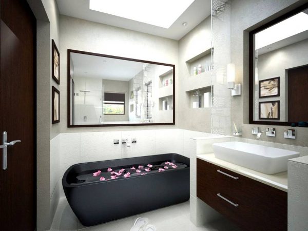 Monochrome bathroom with black tub and mirrors